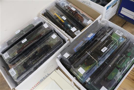 A collection of Amercom model locomotives, each mounted on track in original packaging